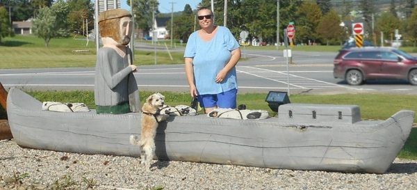 Woman and dog beside canoe at Plaster Rock Welcome Centre